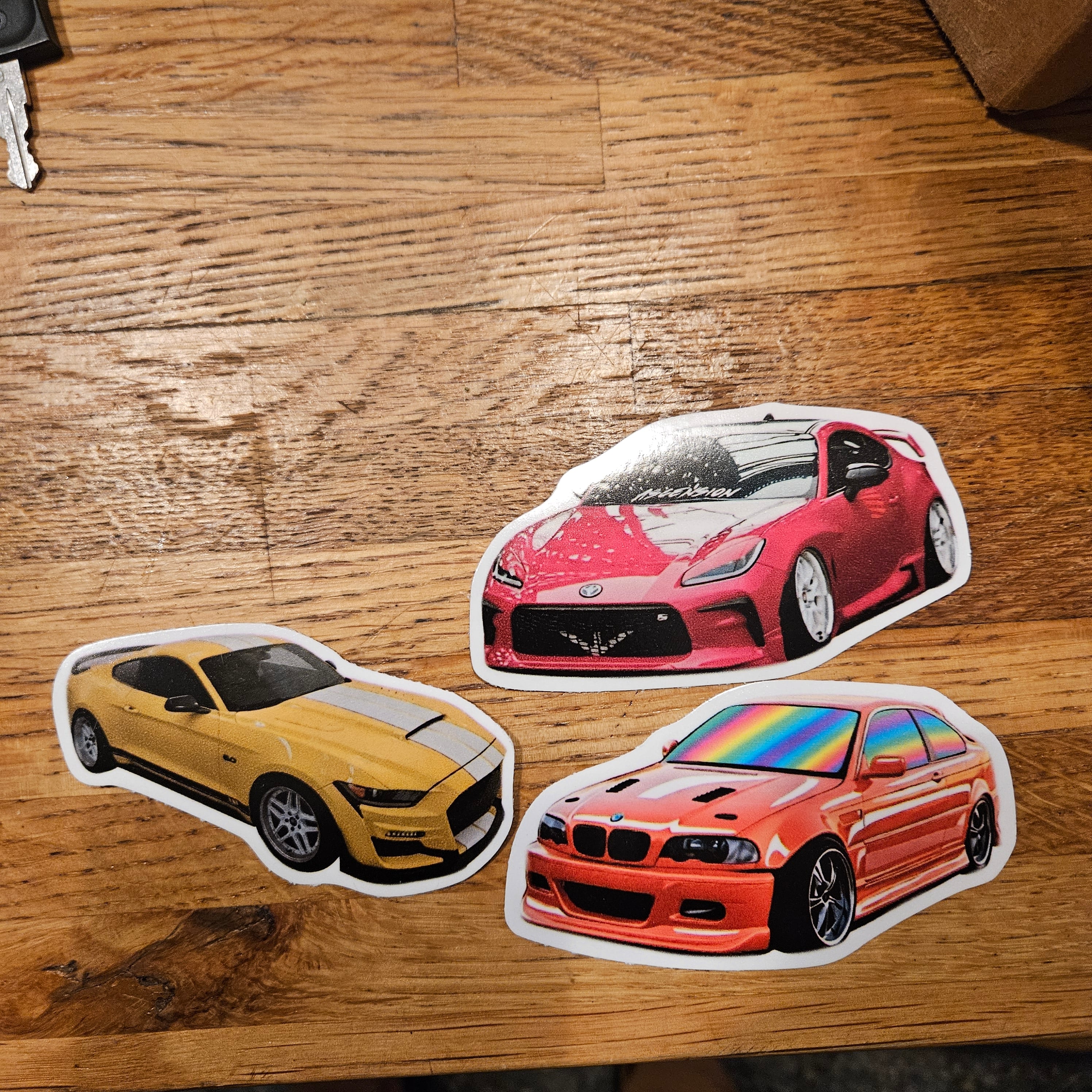 Printed STICKERLY stickers of three cars